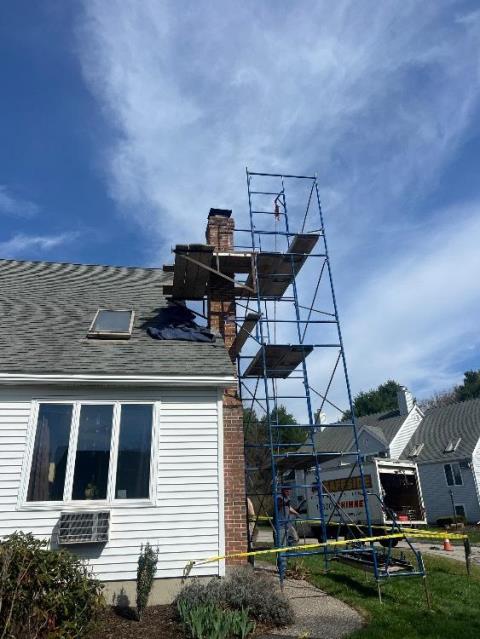 We rebuilt the upper chimney courses with new brick, crown, and flue tiles. We replaced both shoulders and applied water repellent.