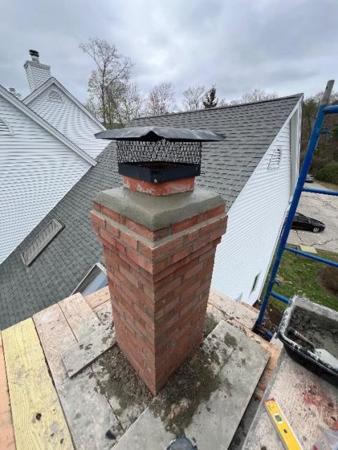 We rebuilt the upper chimney courses with new brick, crown, and flue tiles. We replaced both shoulders and applied water repellent.