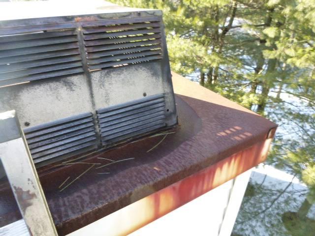 We replaced corroded chimney components with stainless steel, removing buildup. We installed new chase pan, collars, caps, and swept vents.