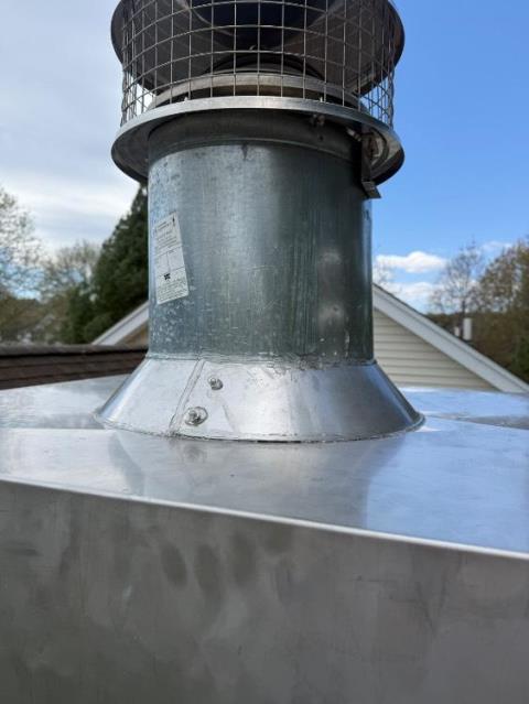 We replaced corroded chimney components with stainless steel, removing buildup. We installed new chase pan, collars, caps, and swept vents.