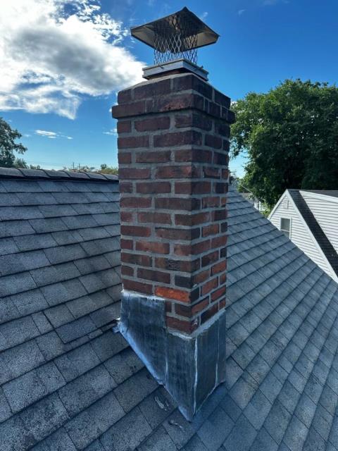 Roof up chimney rebuild in Southington Ct  - with new lead flashing , new brick and mortar and a precast crown