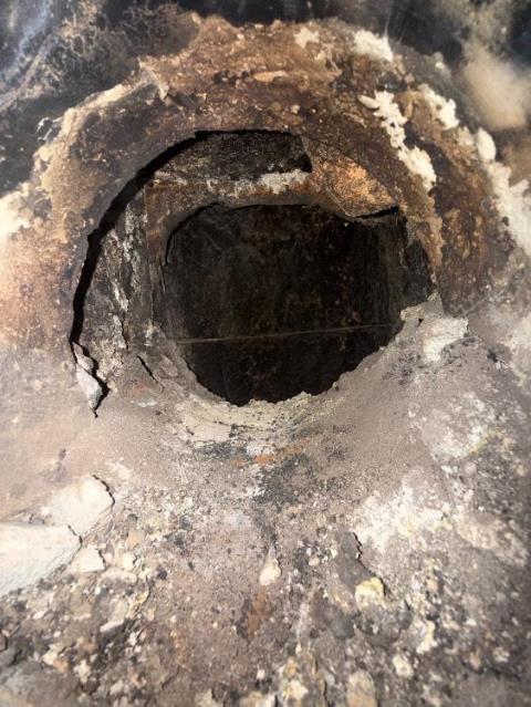 We installed a stainless liner to correct venting and contain acidic exhaust. We replaced connector pipes and cleaned the system to protect remaining masonry.