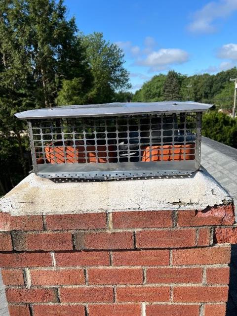 In Windsor, CT, Level 1 Inspection Found The Top of the Chimney Has Saturation and Structural Damages Developing. Rebuilt the top corbeled edge and crown.  Reinstalled customers existing cap.