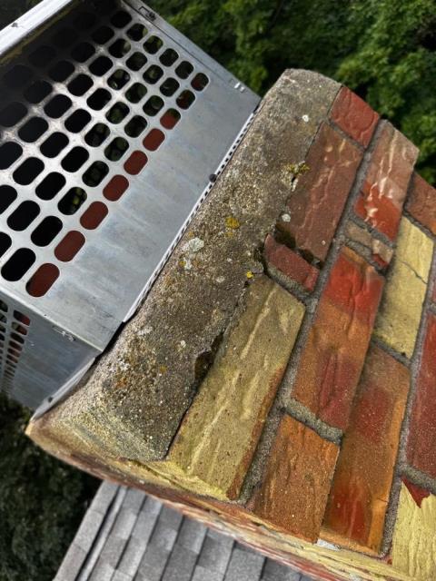 In Vernon, CT, we rebuilt the chimney's shoulder shelf with new bluestone and applied crown coat to seal existing hairline cracks. Treated exterior with water repellent to prevent further weather-related damage.