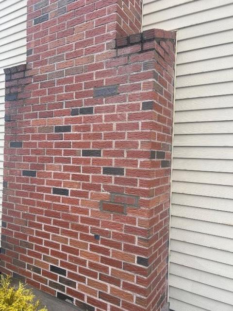 In Manchester, CT, the flue tiles serving the heating system were in poor condition, with two severe offsets located near the fireplace area. In order to properly reline the flue and create a gas-tight venting system, small, surgical masonry breaches were made to remove interior masonry obstructions.
