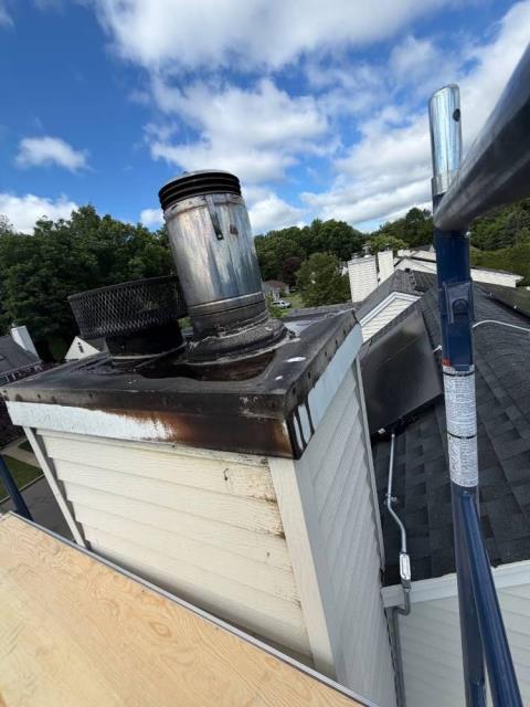 We installed stainless steel chase pans, added termination caps and storm collars, and swept both flues. We also measured for proper fitment and confirmed refractory panel requirements in case the homeowner wants to get those repairs in the future.