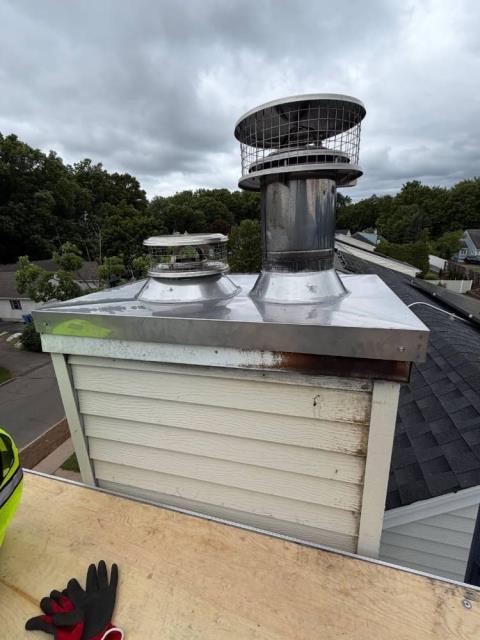 We installed stainless steel chase pans, added termination caps and storm collars, and swept both flues. We also measured for proper fitment and confirmed refractory panel requirements in case the homeowner wants to get those repairs in the future.