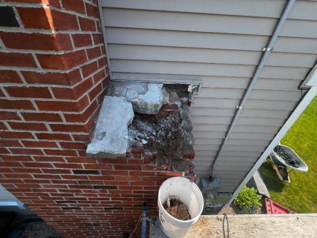 We rebuilt the chimney shoulder with new brick and bluestone, and applied a water repellent to protect the masonry exterior.