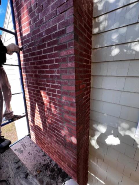 This chimney in Manchester CT had missing mortar and separated bricks on one side of it. We toothed in new bricks and mortar , and repointed other areas , without having to rebuild the whole thing , which was a larger project than the homeowner was prepared for.  In this case , the repair was a viable alternative.