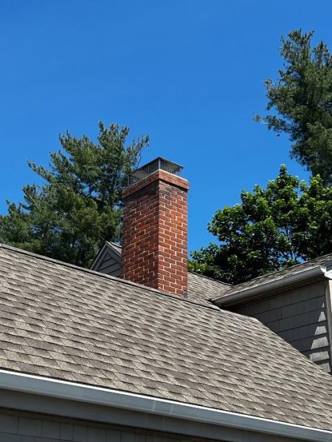 Acidic flue condensation rotted the chimney top, leaving damaged flue tiles, loose masonry, and water-entry points. We're rebuilding the top courses, replacing flue tiles, crown, and installing a protective stainless-steel cap.