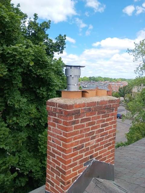 We removed an unsafe galvanized venting system causing draft failure and installed a continuous stainless steel chimney liner to restore safe, efficient venting for both gas appliances.