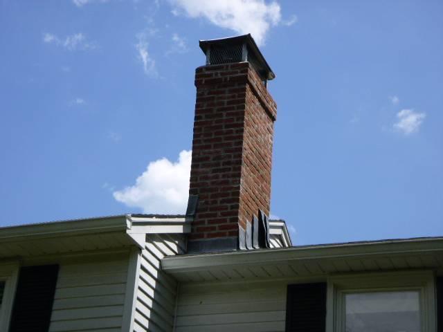 We found a fractured crown and failing flashing allowing water intrusion. We're applying HeatShield, replacing and embedding new lead flashing, repairing the crown, and securing the cap for lasting protection.