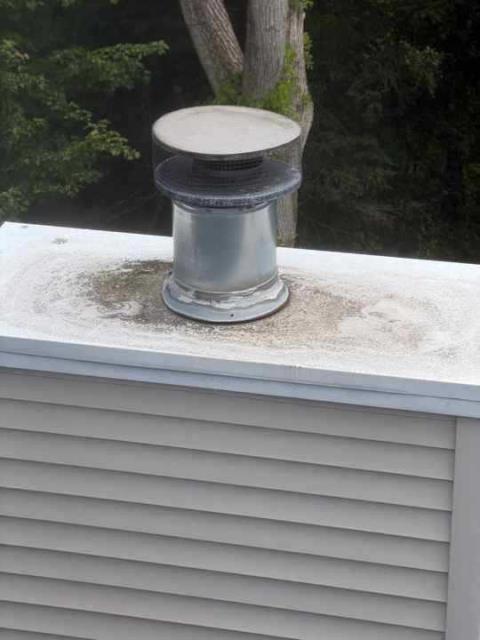 We replaced a failing, leaking chase cover pan in New Milford Ct  and vent flashing and boot with stainless steel components, then swept the oil flue to remove corrosive sulfuric acid deposits causing chimney deterioration.