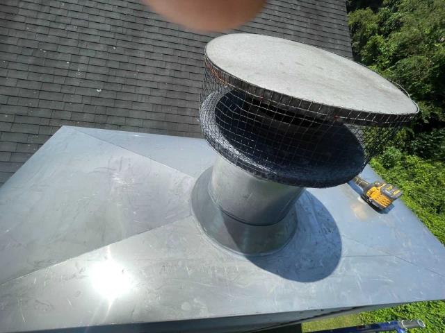 We replaced a failing, leaking chase cover pan in New Milford Ct  and vent flashing and boot with stainless steel components, then swept the oil flue to remove corrosive sulfuric acid deposits causing chimney deterioration.