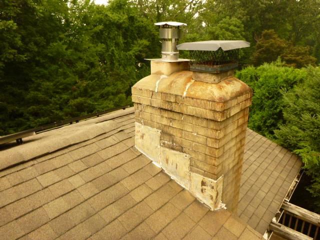 Severe spalling, open mortar joints, crown failure, and loose masonry were allowing water intrusion. We’re rebuilding to the roofline with new brick, flashing, crown, flue tiles, and a stainless cap.