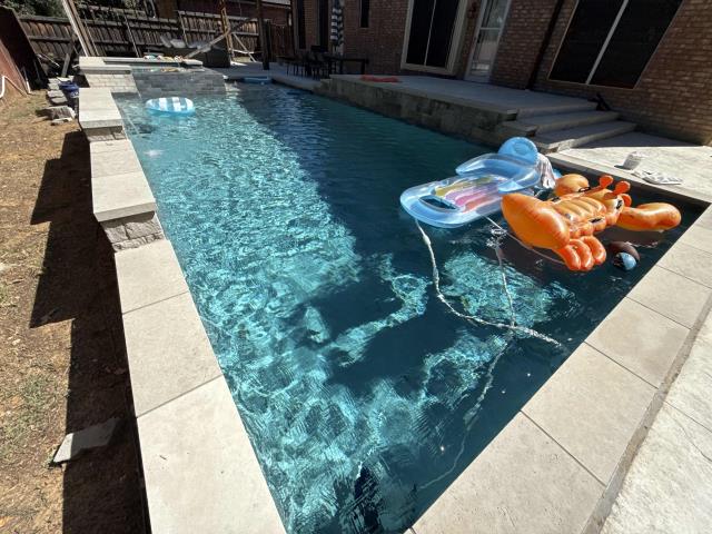 One of our gorgeous weekly pool service accounts in grapevine! This pool in grapevine has a beautiful charcoal Lueders coping and a mini pebble plaster! We love these clients and taking care of their pool maintenance for them!