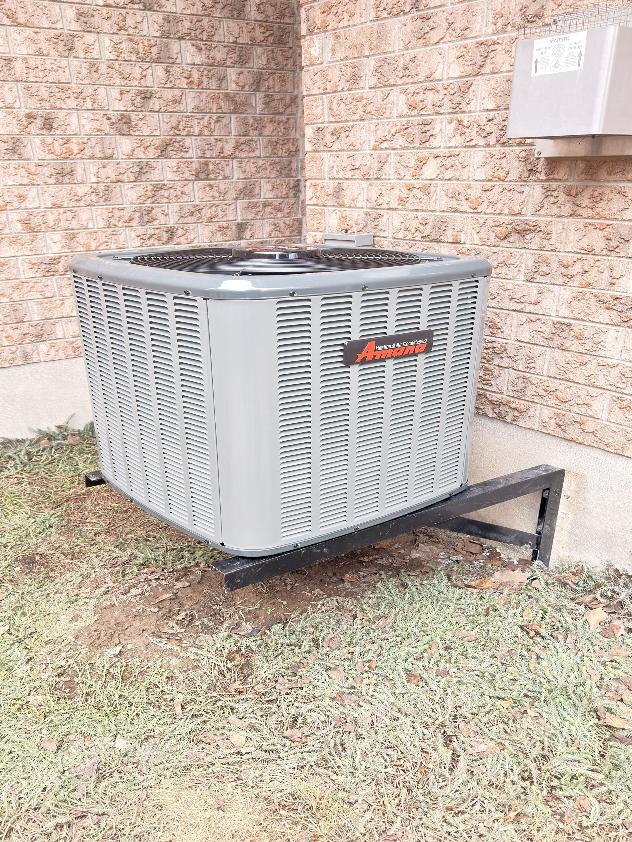 Completing an Amana AC installation for a family in Elora