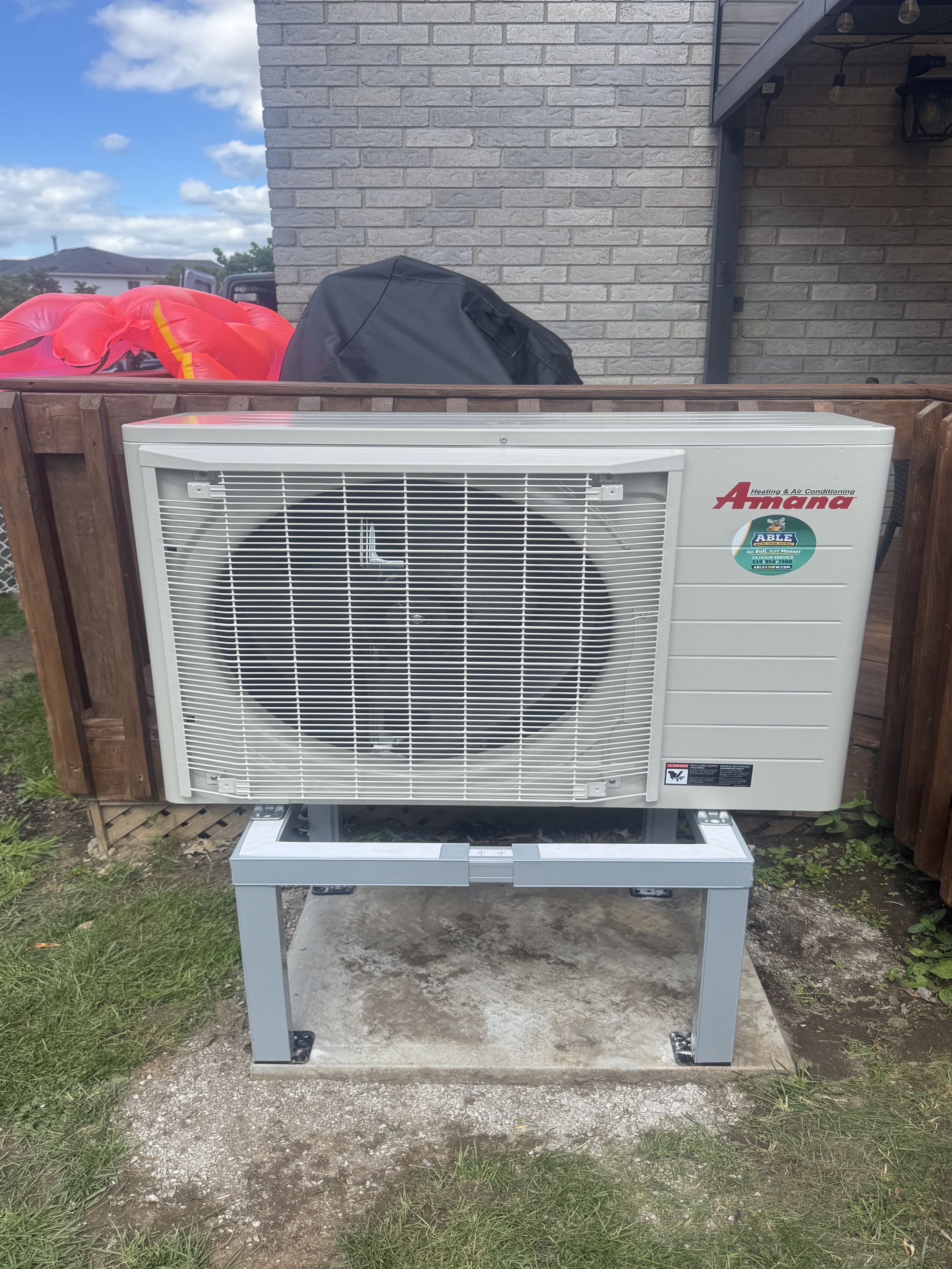 Completing an Amana side discharge AC unit for a family in Victoria Hills area of Kitchener
