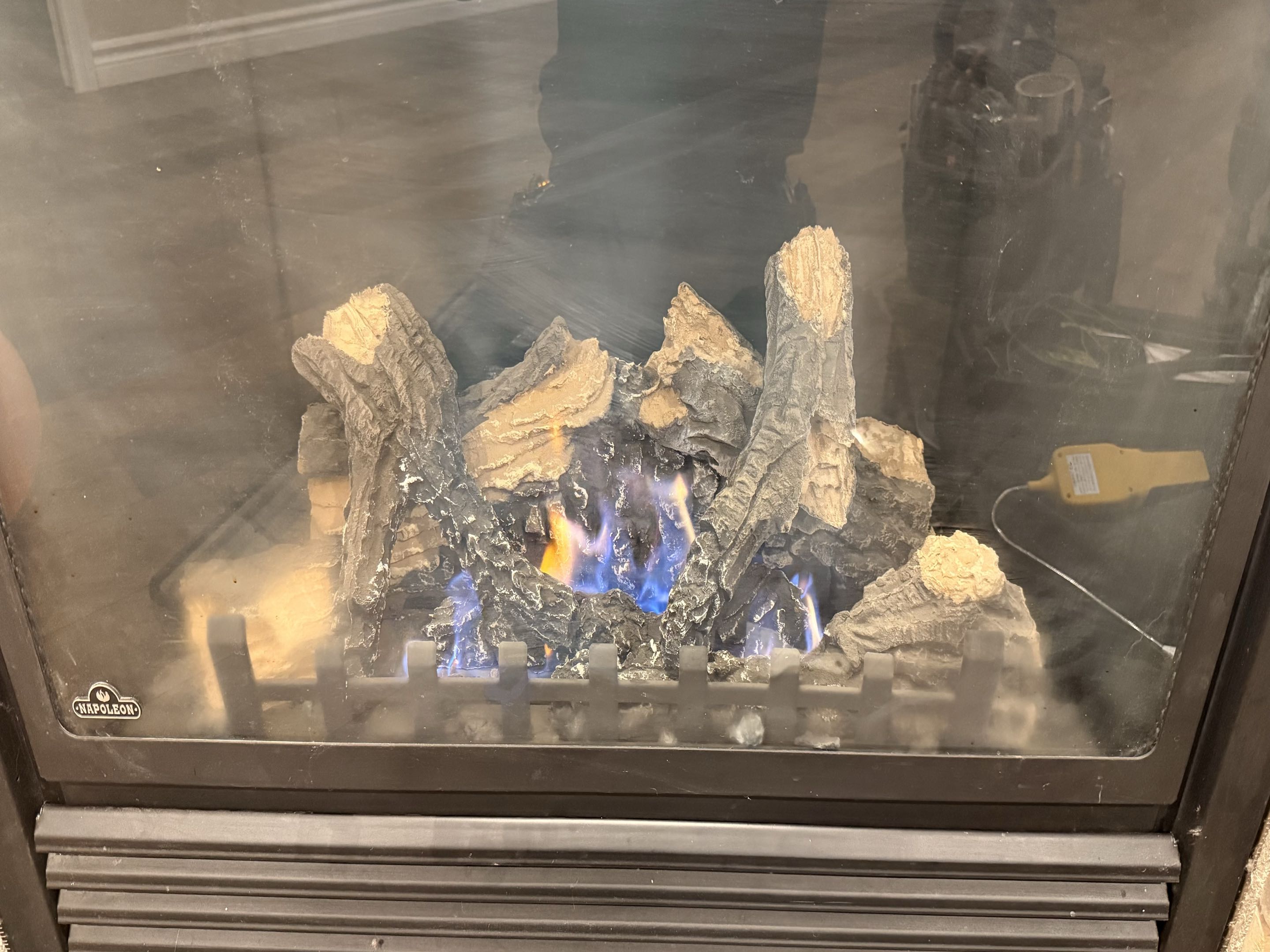 Completed a fireplace tune-up. Cleaned the pilot assembly and glass, checked thermopile output, and confirmed normal operation. Fireplace working properly.