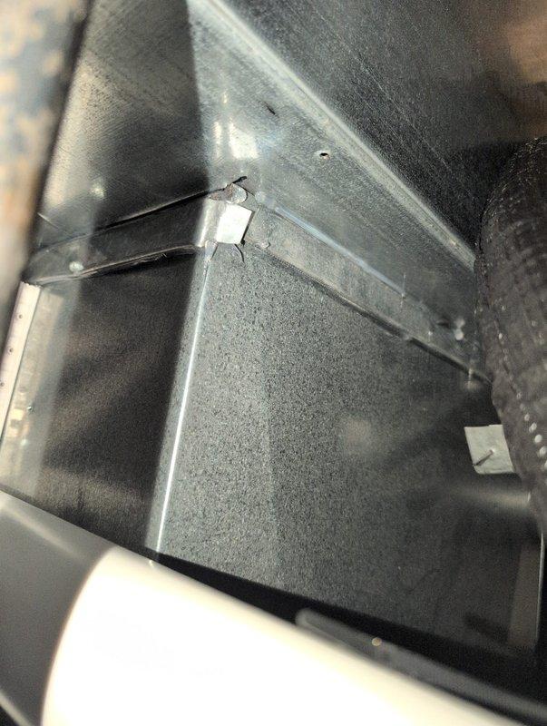 Sealed the return air drop connection where a 2"x2" hole was identified on the back side of the return air drop to the furnace. Applied appropriate sealing materials to ensure proper system operation and prevent air leakage. Inspection photos confirm complete sealing of the compromised area in the ductwork.