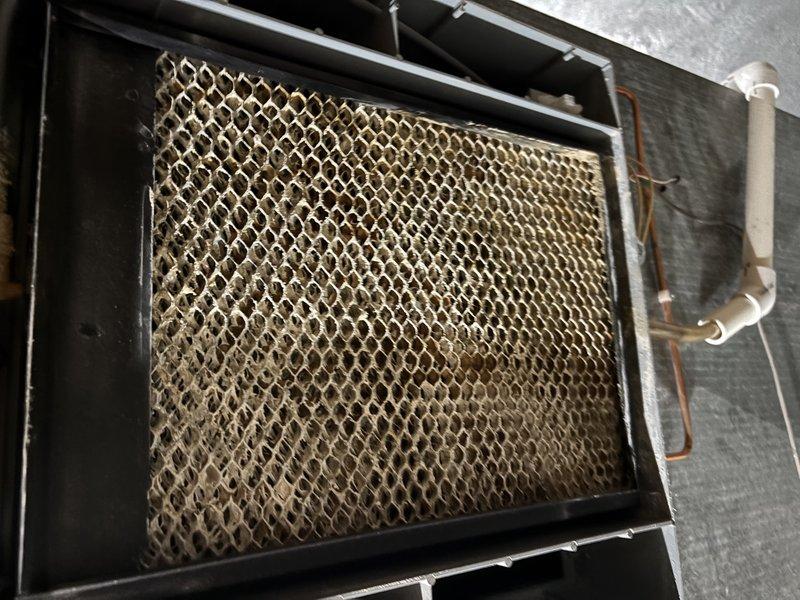 Diagnosed and repaired water leak from 2018 RHE humidifier attached to furnace system. Identified slow drip issue while system maintained overall functionality. Documented condition with photos showing HVAC components and affected area.