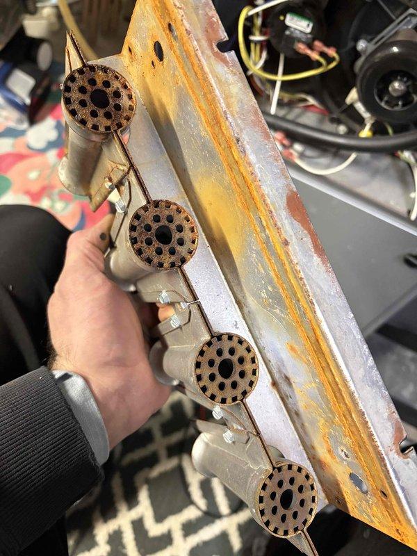 Performed annual furnace tune-up on 8-year-old Napoleon system. Discovered significant corrosion on burner assembly and heat discoloration on flame sensor electrode. Cleaned and tested components, but recommend monitoring system closely as these components may require replacement soon due to deterioration.