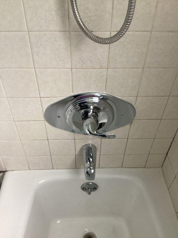 Successfully replaced existing shower valve in bathroom to restore proper functionality. Opened wall access point to remove old valve assembly and installed new chrome single-handle shower control with matching bathtub spout. Verified proper operation after installation with no leaks present.