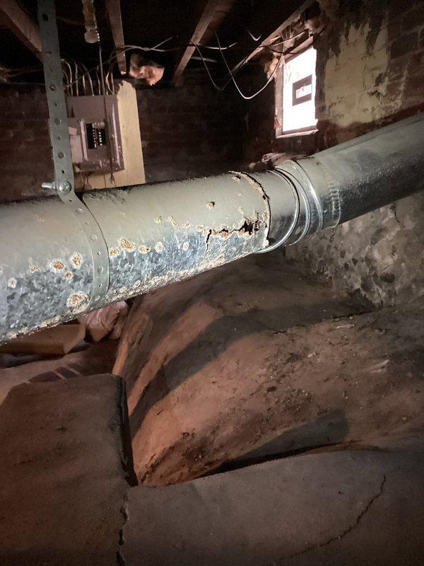 Responded to no-heat call where furnace was blowing cold air. Upon inspection, discovered severe corrosion and deterioration of gas supply pipe with significant blue-green oxidation indicating gas leak potential. Replaced damaged section of gas piping and restored proper gas flow to unit, allowing system to ignite and produce heat correctly.