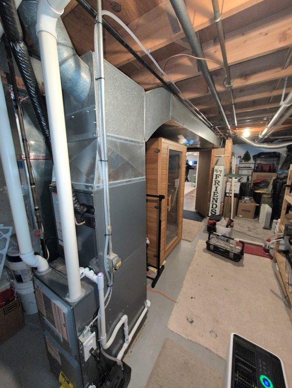 Responded to inspector correction by rerouting sump pump drain line to sanitary drain system. Installed condensate pump with integrated GFCI combo plug and added proper drain trap to ensure code compliance. System now properly drains from the Daikin HVAC equipment in basement utility room without risk of backflow.