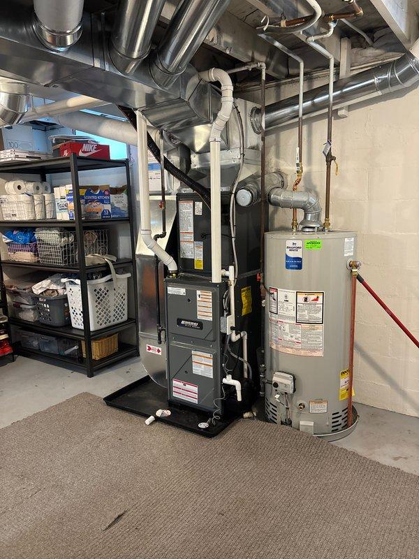 Successfully installed new furnace in residential basement, properly connecting to existing ductwork system and ensuring proper ventilation through PVC piping. System was mounted on protective base plate with all safety labels in place and is functioning as designed.