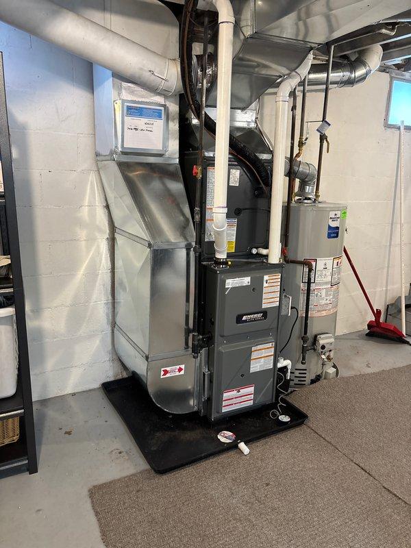 Successfully installed new furnace in residential basement, properly connecting to existing ductwork system and ensuring proper ventilation through PVC piping. System was mounted on protective base plate with all safety labels in place and is functioning as designed.