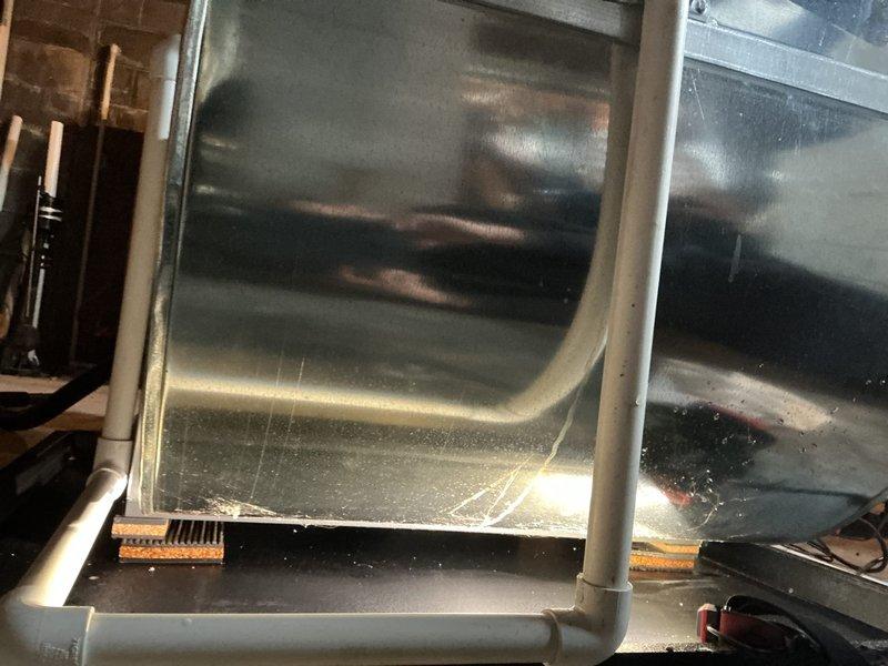 Responded to water leak complaint at furnace base pan. Inspected HVAC system and discovered condensate drain line blockage causing water accumulation. Cleared obstruction in PVC drainage pipe connected to ductwork and verified proper drainage function. Serviced humidifier which was not operating due to related drainage issues. System now functioning properly with no visible leaks.