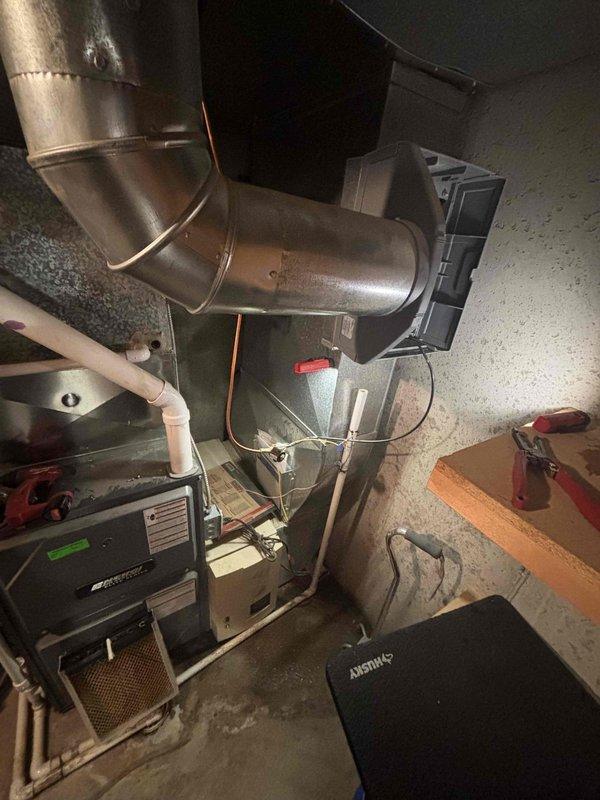 Responded to service call for a leaking Aprilaire humidifier installed on ductwork of a 20+ year old HVAC system. Diagnosed water leak originating from the aging humidifier unit, which had deteriorated components but was still allowing the heating and cooling system to function properly. Recommended replacement due to age and condition of the unit.