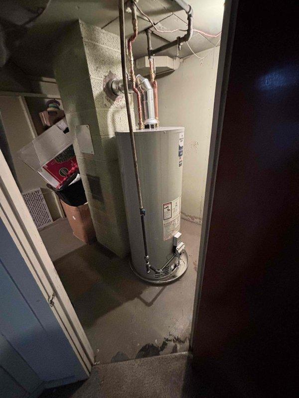 Successfully installed a new Bradford White water heater in utility room, replacing existing unit. Completed all necessary plumbing connections including copper inlet/outlet lines and installed proper control valve. System is operational with all connections secure.