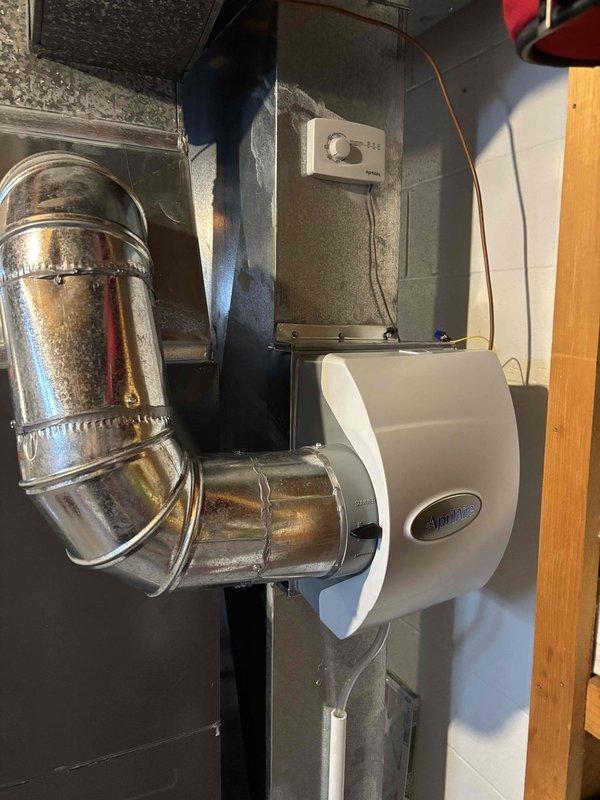 Successfully installed an Aprilaire 600 Manual humidifier on customer's HVAC system in basement. Unit was properly mounted to the furnace with galvanized ductwork connections and wired to the wall-mounted humidistat. Completed necessary plumbing connections to water supply line using copper fittings and insulated piping per manufacturer specifications.