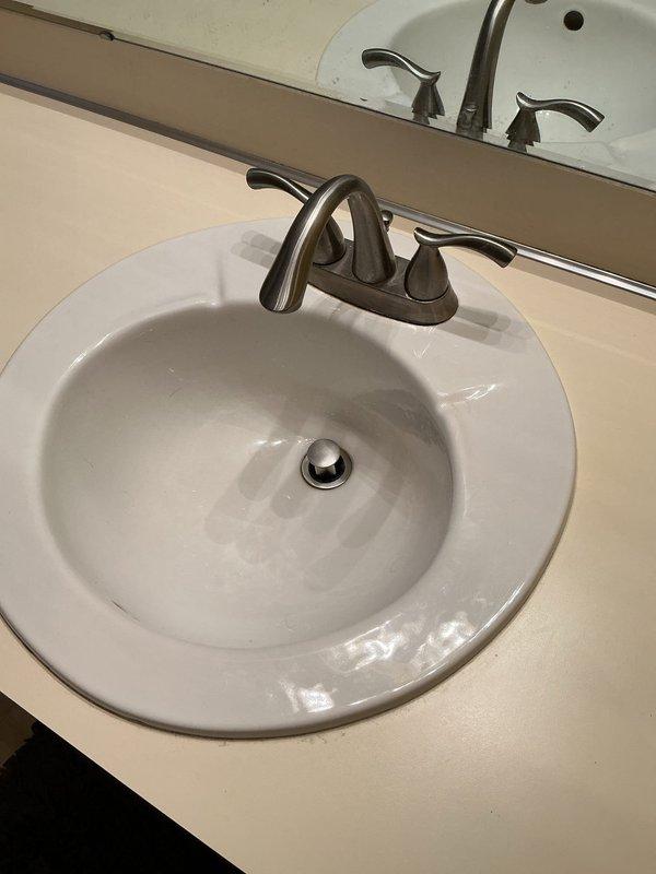 Responded to service call for multiple bathroom plumbing issues. Repaired broken shower control valve, replaced bathroom sink pop-up drain assembly to restore proper stopper function, and replaced worn wax ring seal on toilet to eliminate floor leak as evidenced by water accumulation on tile.