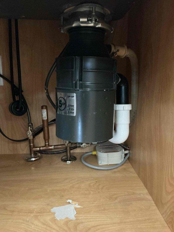 Diagnosed and repaired sink leak at garbage disposal connection. Inspected under-cabinet plumbing system including PVC drainage pipes and copper supply lines. Resolved issue by properly sealing disposal unit connections, eliminating the leak that customer reported had been occurring for two days.