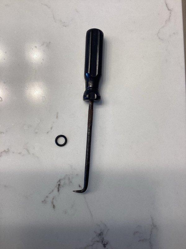 Addressed low water pressure issue in bathroom by replacing worn O-ring gasket using specialized pick tool. Successfully installed new chrome shower head with improved spray pattern to restore proper water flow functionality.