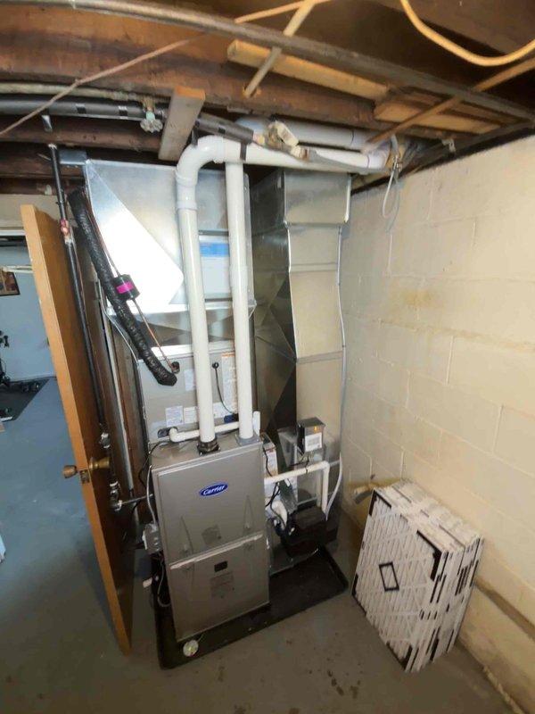 Successfully completed installation of new Carrier furnace system and outdoor AC unit. All equipment properly mounted with appropriate connections to existing ductwork and properly vented with PVC pipes. System installed on concrete pad with copper refrigerant lines properly connected to home.