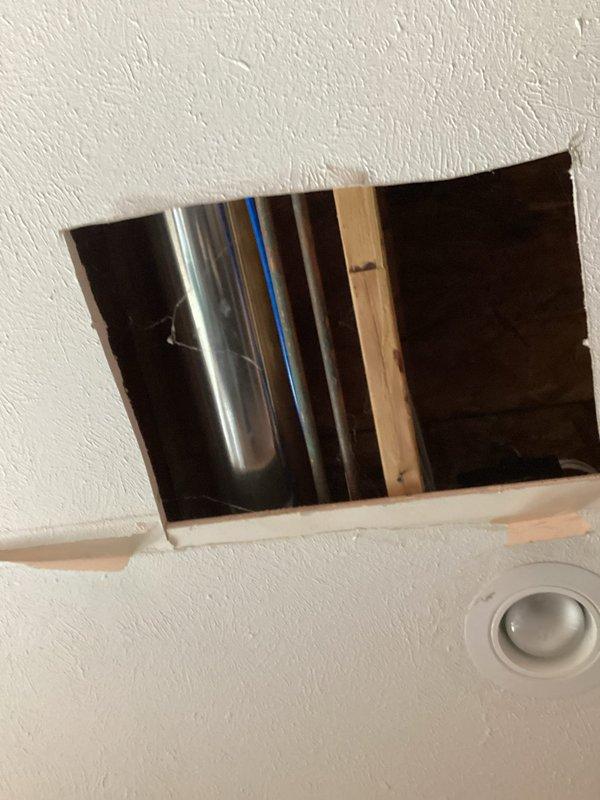 Conducted site assessment for new island prep sink installation, focusing on plumbing requirements. Inspected ceiling access points to evaluate existing water supply lines and drainage infrastructure. Documented current conditions including visible piping configuration and structural elements to determine optimal connection points for the proposed fixture.