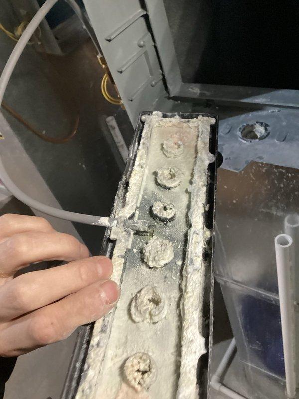 Responded to water leak service call for 9-year-old Carrier unit with warranty through 11-2026. Diagnosed severe frost buildup on evaporator coil causing water leakage while furnace continued heating operation. Identified significant mineral scale accumulation on components. Defrosted system and performed necessary cleaning to restore proper operation.