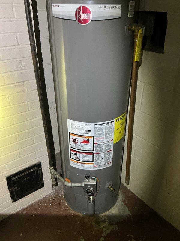 Conducted water heater assessment for a family of 6 at property owned by Hope Church of Kalamazoo. Evaluated existing Rheem Professional unit showing signs of deterioration and documented current installation with copper piping and PVC drain configuration. Prepared estimate for replacement with larger capacity water heater to accommodate household needs, along with separate quote for unrelated plumbing re-route work as requested.