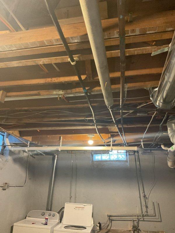 Successfully installed new gas line from basement to kitchen stove location, including proper appliance connector and shut-off valve as quoted. Completed installation in basement with exposed piping properly secured to joists, ensuring safe connection to the stainless steel cooktop with four burners.