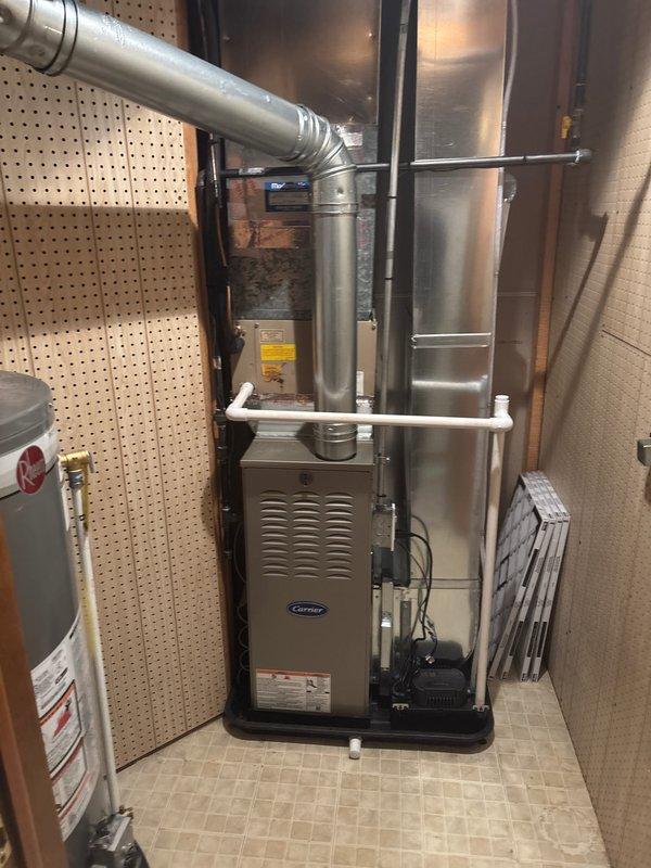 Successfully completed installation of new Carrier furnace unit with complete ductwork connection. Replaced severely corroded and deteriorated venting system, installing new metal ductwork with proper sealing at all joints. System was fully tested and is now operating at optimal efficiency.