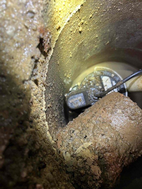 Responded to service call for continuously running sump pump with empty basin. Inspection revealed significant corrosion and scale buildup on pump components and check valve failure causing water to backflow into basin, triggering constant pump operation. Replaced check valve, cleaned pump assembly, and verified proper operation with normal cycling.