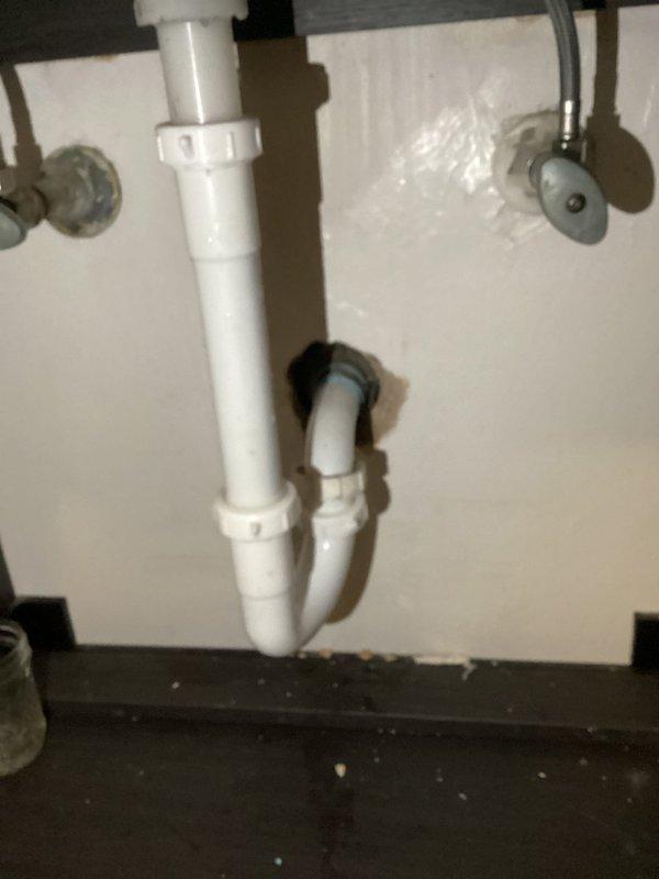 Responded to a plumbing leak service call where water was leaking from bathroom vanity into basement. Inspected the under-sink P-trap configuration and drainage system. Identified and repaired faulty compression fittings that were causing water to seep through and damage the basement ceiling below. Tested system after repair to confirm proper function with no further leakage.