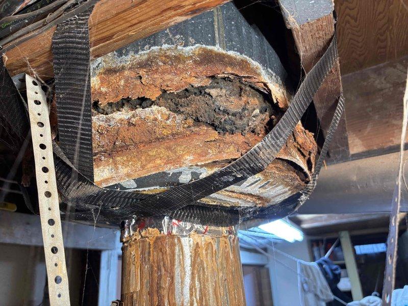 Performed annual heating service on 33-year-old Utica boiler. Discovered severely corroded exhaust vent pipe with advanced deterioration, extensive rust, and structural compromise despite temporary nylon strap support. Documented condition with photos for customer reference.