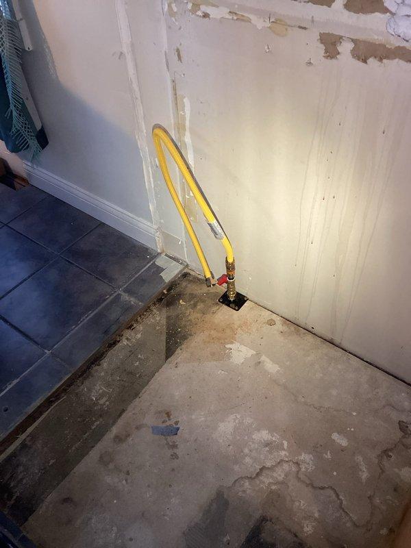 Returned to complete gas line installation as requested. Successfully ran a new gas line through structural framing, ensuring proper support along wooden beams with appropriate labeling. Connected the yellow gas line to a brass fitting mounted on a floor plate in the renovation area, completing the CWOW service requirement.