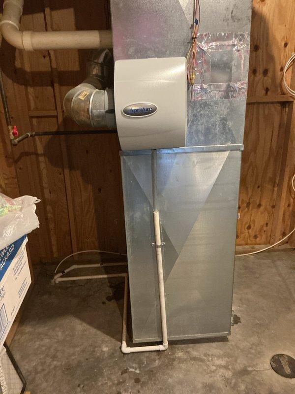 Successfully installed a manual Honeywell humidifier unit on the existing HVAC system, properly mounting it to the metal ductwork in the utility room. The installation included all necessary connections to the AirEase furnace system, ensuring proper integration with existing plumbing and electrical components for optimal humidity control.