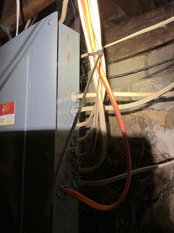 Inspected separated pole mast caused by falling ice damage. Evaluated electrical panel connections in basement to ensure integrity of service was maintained despite exterior mast separation. Documented existing installation with photos for accurate repair estimation.
